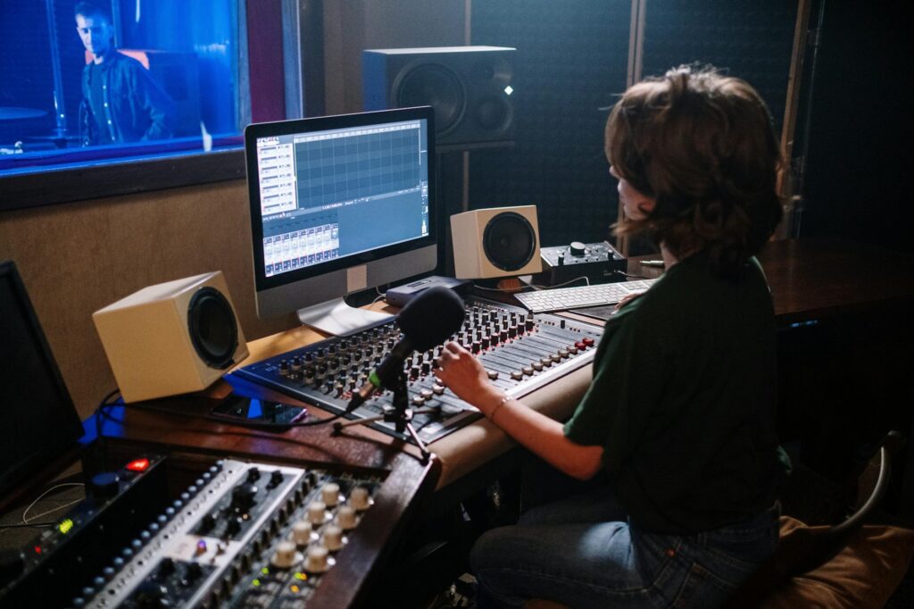 woman sitting in a recording production studio